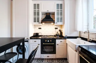 a kitchen with white cabinets and an oven at Cozy Flat with Balcony Near Istiklal Avenue in Istanbul