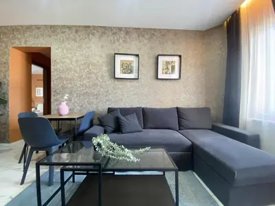 a living room with a blue couch and a table at Central Comfortable Flat in Historic Balat in Istanbul
