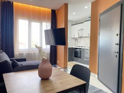 a living room with a dining table and a kitchen at Central Comfortable Flat in Historic Balat in Istanbul