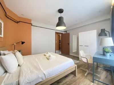 a bedroom with a white bed and a blue desk at Central Comfortable Flat in Historic Balat in Istanbul