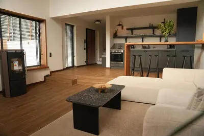 a living room with a white couch and a table at Cevizdibi Loft Villa in Kartepe
