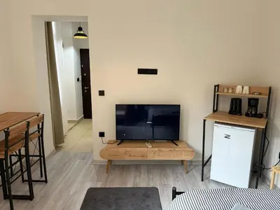 a living room with a flat screen tv and a table at Bono Apartments Kadıköy in Istanbul