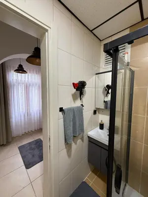 a bathroom with a shower and a sink at Bono Apartments Kadıköy in Istanbul