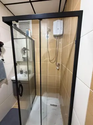a shower with a glass door in a bathroom at Bono Apartments Kadıköy in Istanbul