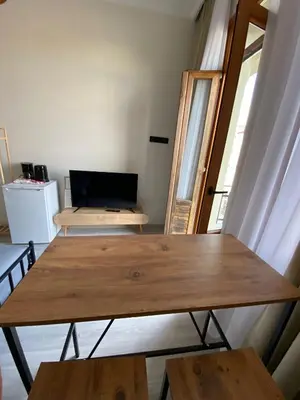 a table and benches in a room with a window at Bono Apartments Kadıköy in Istanbul