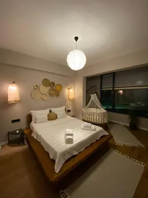 a bedroom with a large bed and a large window at Fcvillasapanca in Sapanca