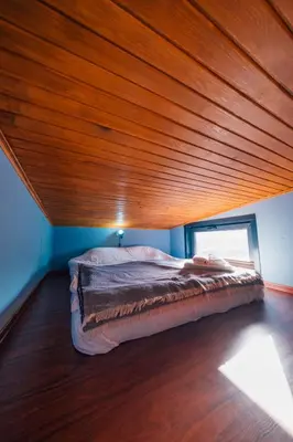 a bed in a room with a wooden ceiling at Sapanca Sunday Bungalov Resort Otel in Sapanca