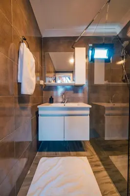 a bathroom with a white sink and a shower at Sapanca Sunday Bungalov Resort Otel in Sapanca