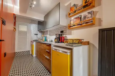 a kitchen with yellow cabinets and a yellow dishwasher at Cosy Apartment in Beyoglu in Istanbul