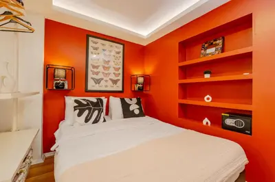a bedroom with orange walls and a bed at Cosy Apartment in Beyoglu in Istanbul