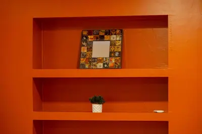 a shelf with a mirror and a potted plant at Cosy Apartment in Beyoglu in Istanbul