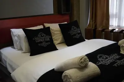 a bed with black and white pillows and towels at SE Group Corner Suites in Istanbul