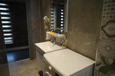 a bathroom with a sink and a mirror at SE Group Corner Suites in Istanbul