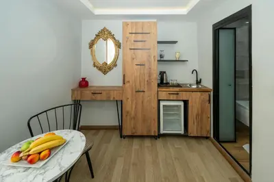 a kitchen with a table with a plate of fruit at Deluxe Valeria in Istanbul