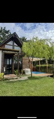 a small house with a tree in the yard at Galaxy Housing