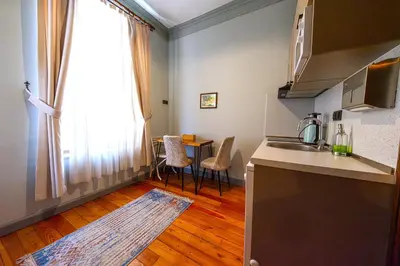 a kitchen with a sink and a table with chairs at Flex Pera in Istanbul