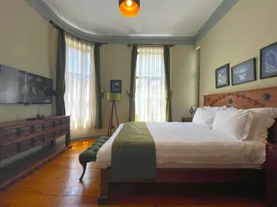a bedroom with a large bed and two windows at Flex Pera in Istanbul