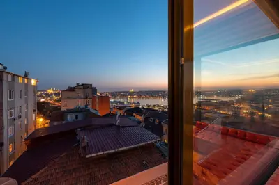 a view from a window of a city at night at Flex Pera in Istanbul
