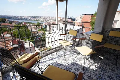 a group of chairs and tables on a balcony at i1 Historic House Hotel with Gorgeous View in Istanbul