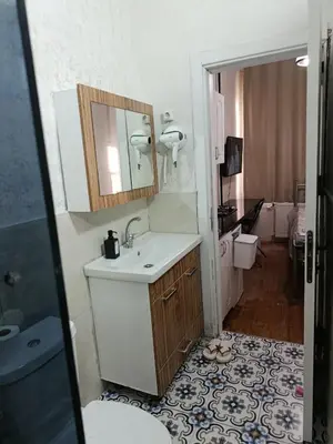 a bathroom with a sink and a mirror and a toilet at i1 Historic House Hotel with Gorgeous View in Istanbul