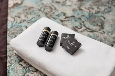 two black liquids sitting on top of a towel at Dencity Hotels & Spa in Istanbul