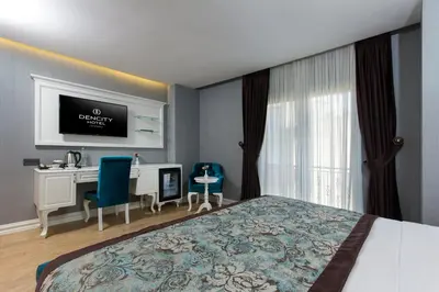a bedroom with a bed and a desk and a tv at Dencity Hotels & Spa in Istanbul