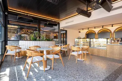 a restaurant with wooden tables and chairs at Premier Lounge Hotel in Tuzla