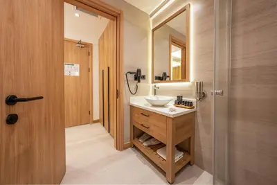 a bathroom with a sink and a mirror at Premier Lounge Hotel in Tuzla
