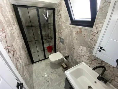 a bathroom with a sink and a toilet at Ege Naz Villa in Avsa Adasi