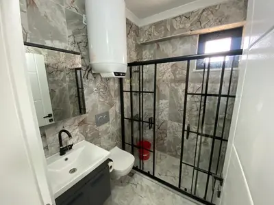 a bathroom with a sink and a toilet and a mirror at Ege Naz Villa in Avsa Adasi