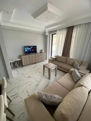 a living room with a couch and a tv at Ege Naz Villa in Avsa Adasi