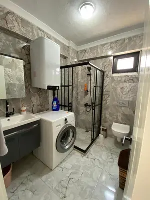 a bathroom with a washing machine and a sink at Ege Naz 1 in Marmara