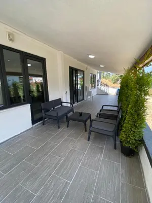a patio with benches and plants on a building at Ege Naz 1 in Marmara