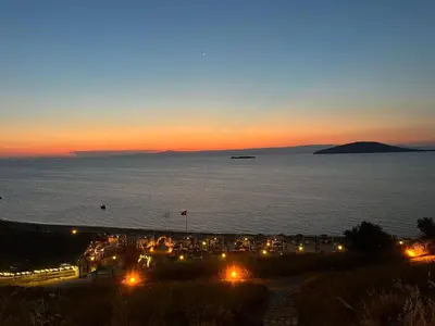 a view of a beach at night with the ocean at Ege Naz 1 in Marmara
