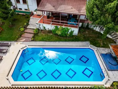 an overhead view of a swimming pool in front of a house at Manzara Ödüllü Büyük Havuzlu Premium Villa in Dibektaş