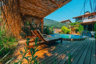 a deck with a pool and a chair and a tree at Sapanca Villa Şen in Sapanca
