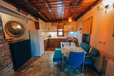 a kitchen with a table and chairs and a refrigerator at Sapanca Villa Şen in Sapanca