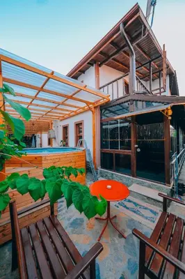a patio with two chairs and a table and a building at Sapanca Villa Şen 2 in Sapanca