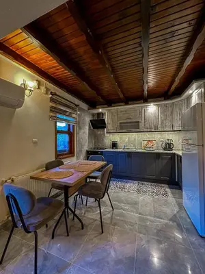 a kitchen with a table and chairs and a refrigerator at Sapanca Villa Şen 2 in Sapanca