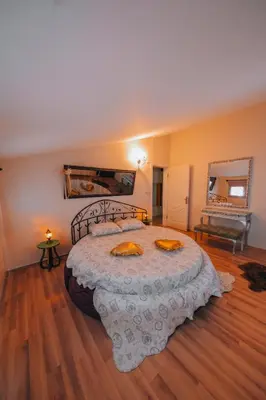 a bedroom with a large bed and a mirror at Sapanca Villa Şen 2 in Sapanca