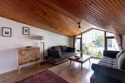 a living room with two couches and a table at 3BR Villa with Garden & Terrace in Kadikoy in Istanbul