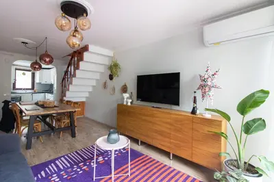a living room with a flat screen tv on a wall at 3BR Villa with Garden & Terrace in Kadikoy in Istanbul
