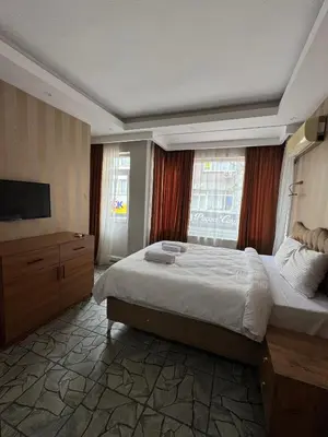 a bedroom with a large bed and a television at beyzade palace in Istanbul