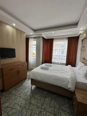a bedroom with a large bed and a large window at beyzade palace in Istanbul