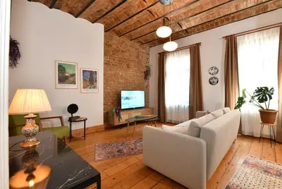 a living room with a couch and a table at Charming Flat Retro Design AC Galata in Istanbul