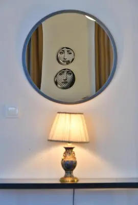 a mirror above a lamp and a vase in a room at Charming Flat Retro Design AC Galata in Istanbul