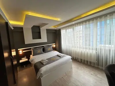 a bedroom with two beds and a large window at Sara Suit in Istanbul