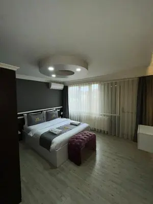 a bedroom with a large bed and a large window at Sara Suit in Istanbul
