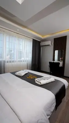 a bedroom with a large bed with towels on it at Sara Suit in Istanbul