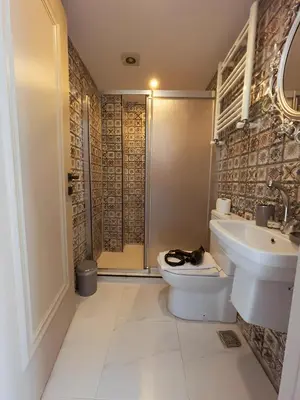 a bathroom with a toilet and a sink and a shower at The Lumina Hotel in Istanbul